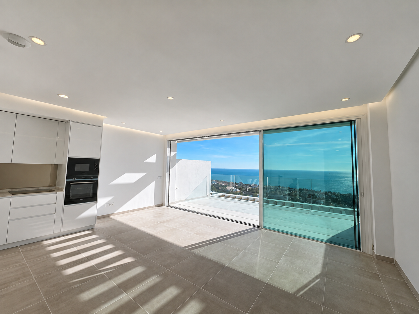 Unfurnished open-plan living room with coastal view